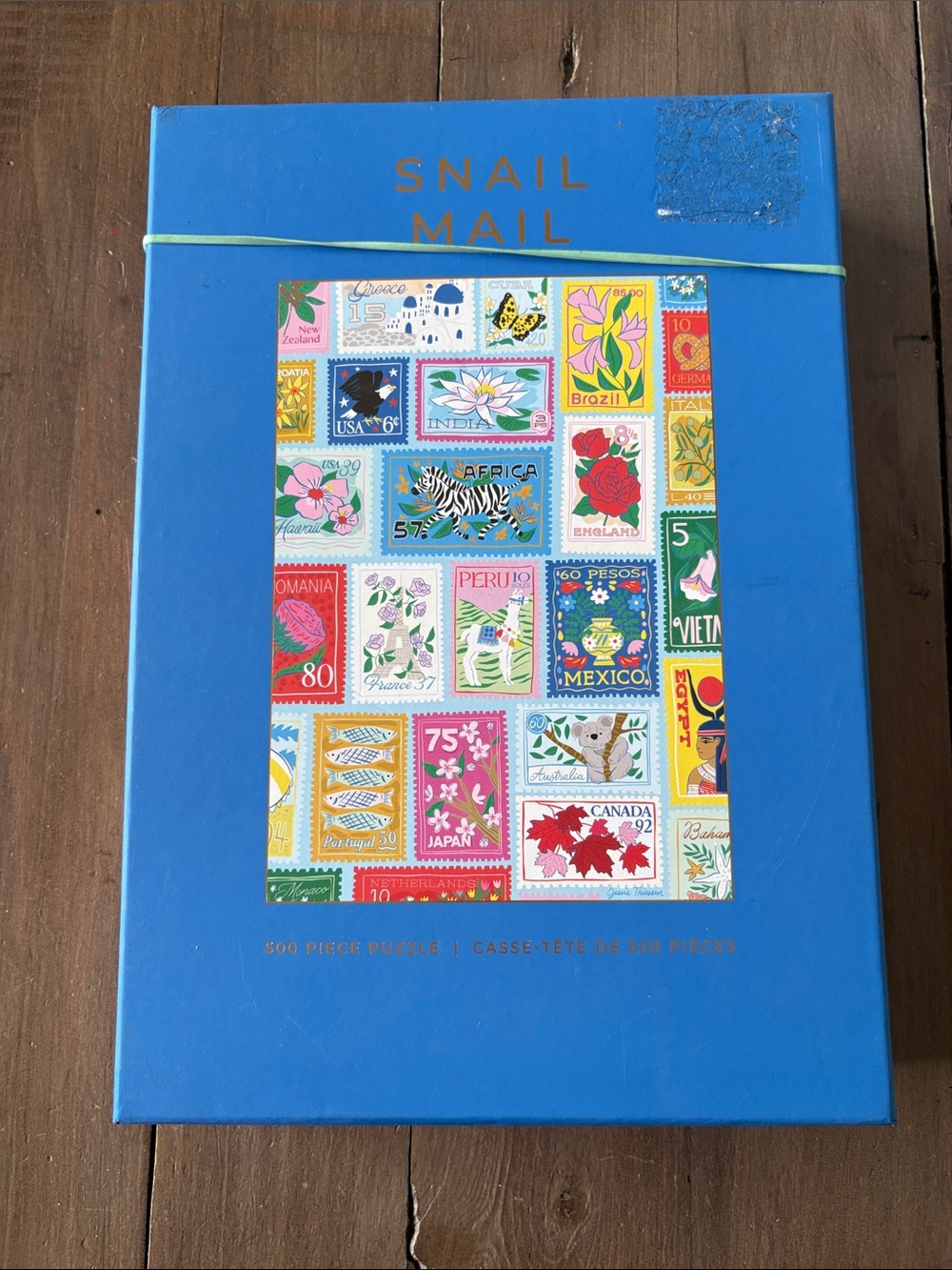 Hobbry Snail Mail 500-Piece Puzzle - Bright Blue Box with Colorful Stamps Matte